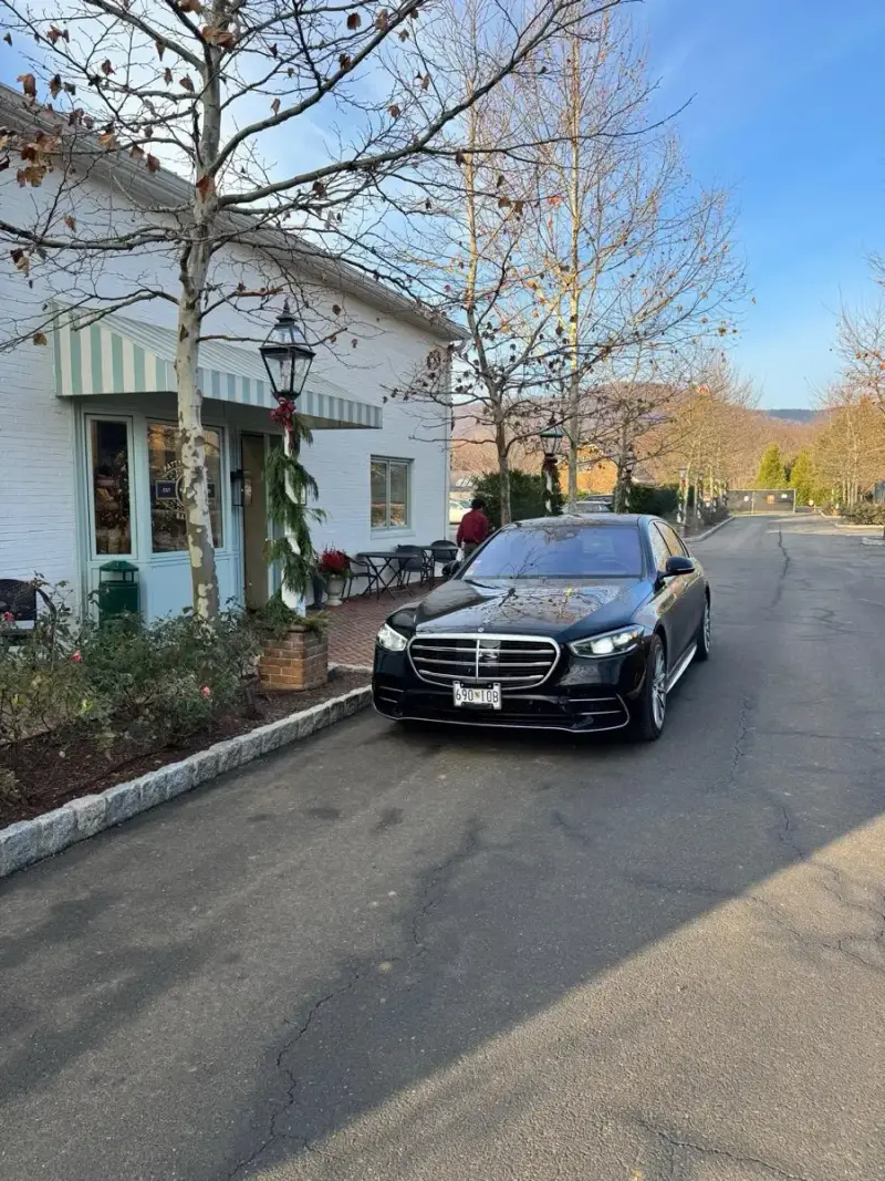 Mercedes-Benz S-Class arriving for a morning pickup outside a country bakery
